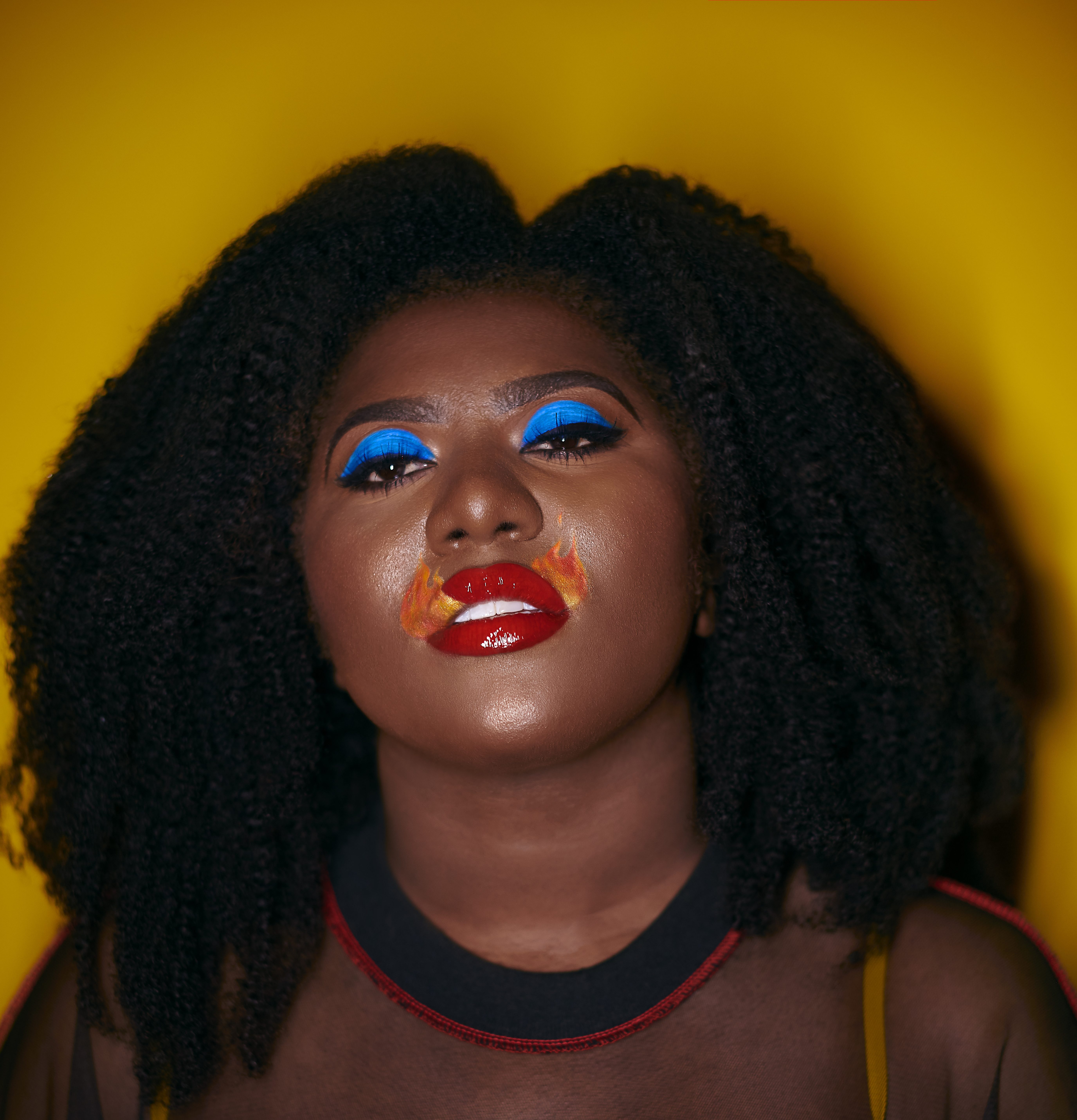 Photo of Exmiranda with red bold flame lip and blue eye shadow